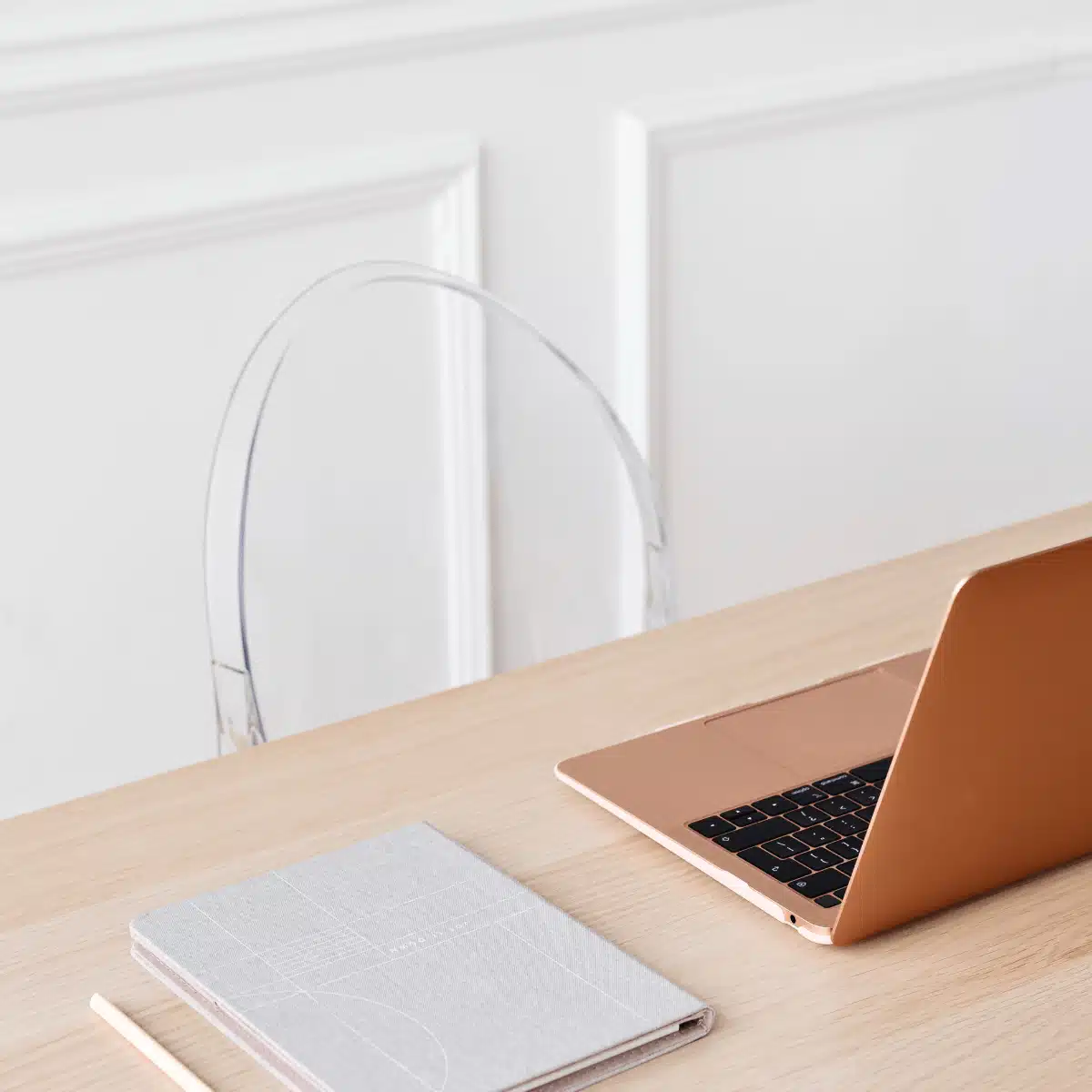 Mindful tech for women – rose gold laptop and notebook on minimalist wooden desk