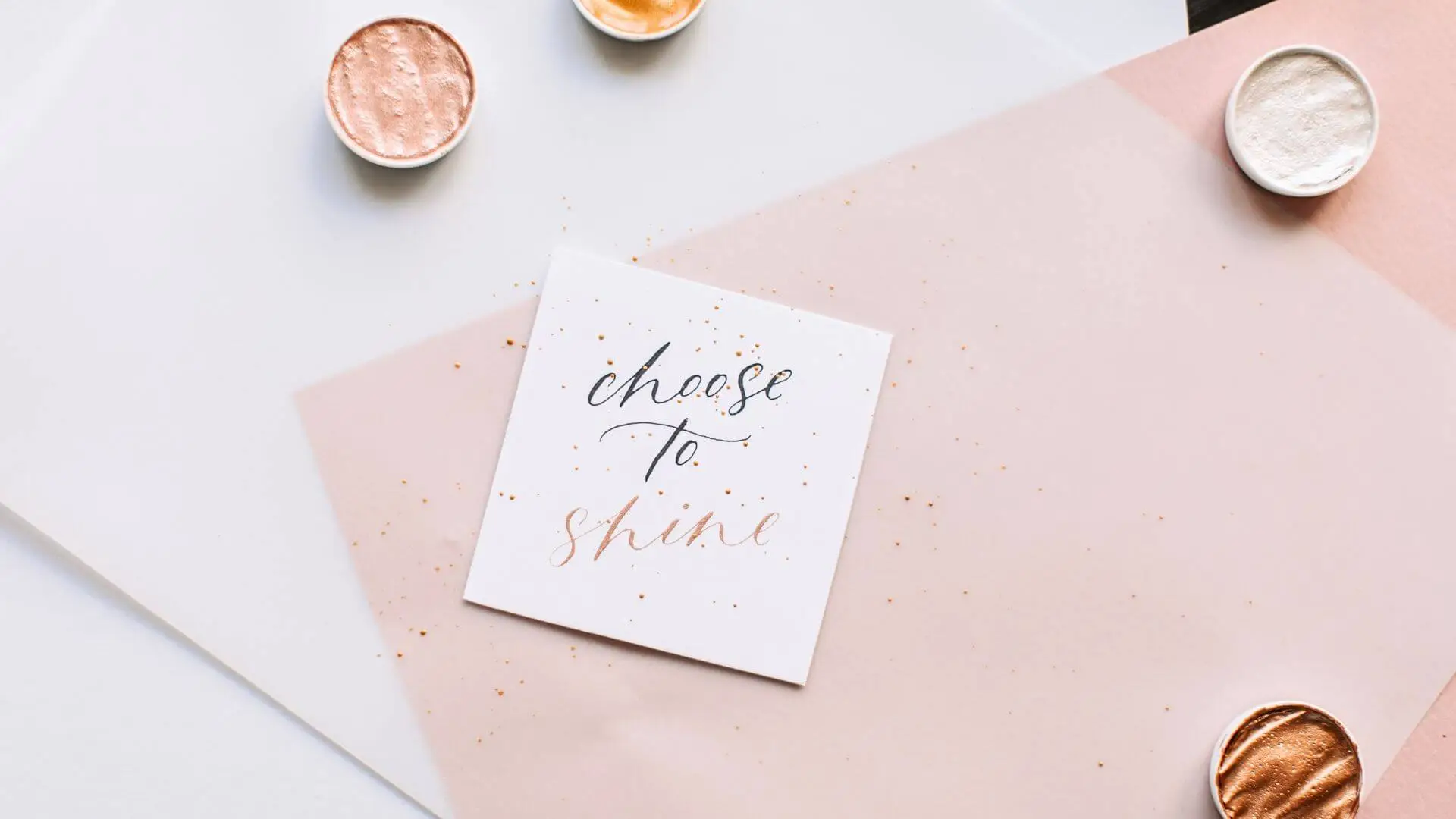 Flatlay with soft neutral tones and a handwritten card that says 'Choose to shine' – inspirational and feminine setting