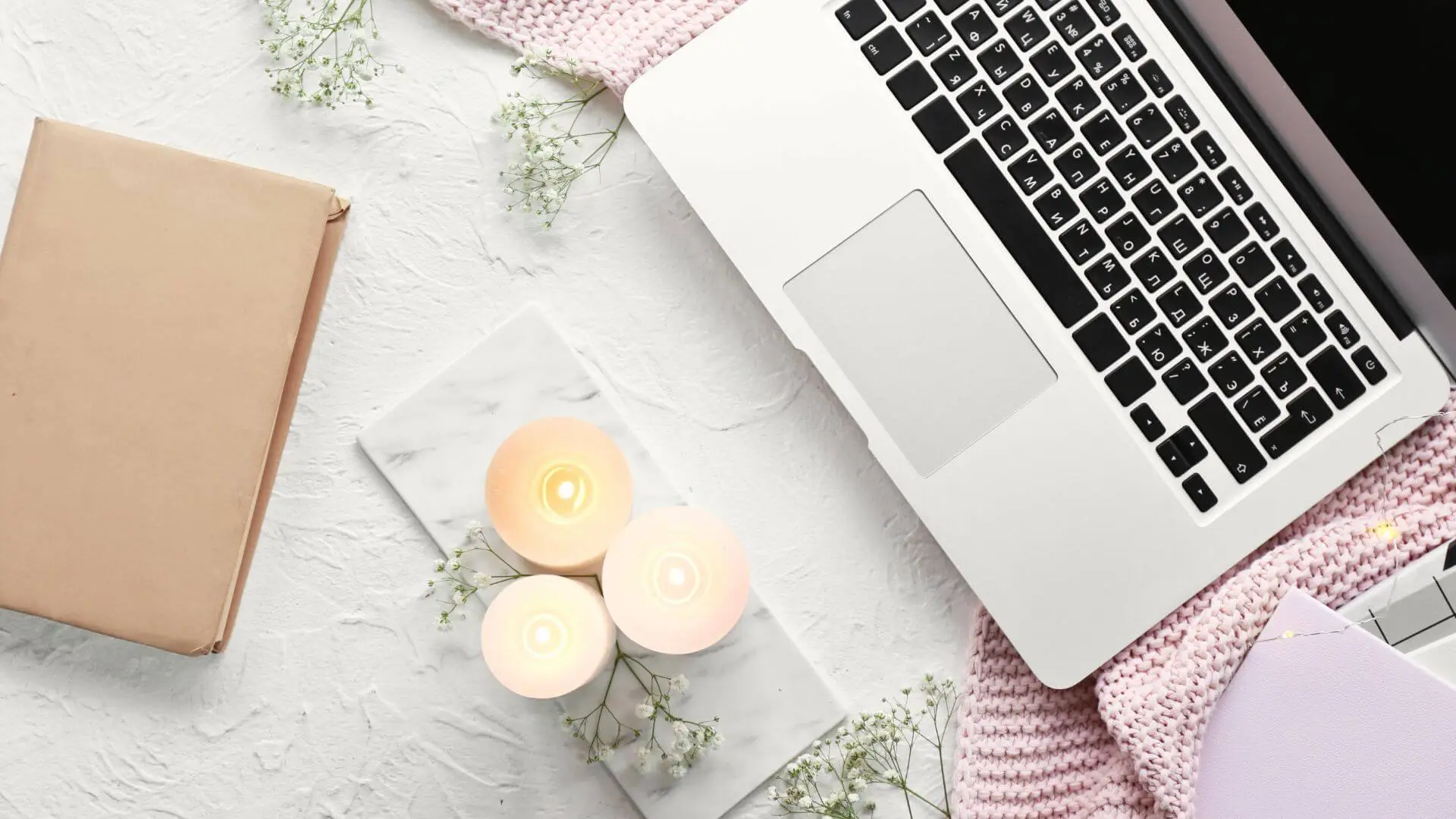 Laptop, candles, and notebook — Mindful Tech Tools for a balanced, creative workflow