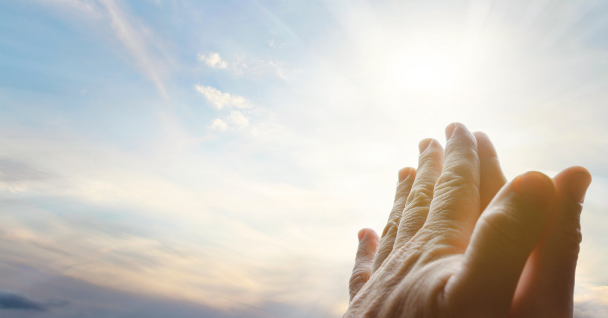 Hands lifted in prayer asking God for peace, protection, and healing before surgery.